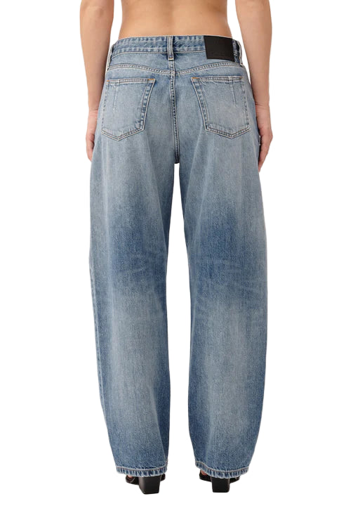 Blue jeans worn by a person on a white background