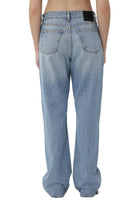 Light blue jeans worn by a person on a white background