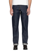 Person wearing dark blue jeans on a white background