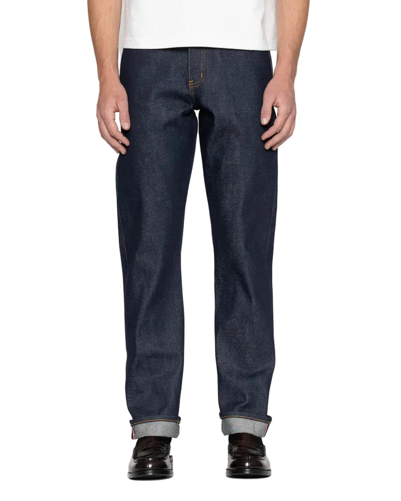 Person wearing dark blue jeans on a white background