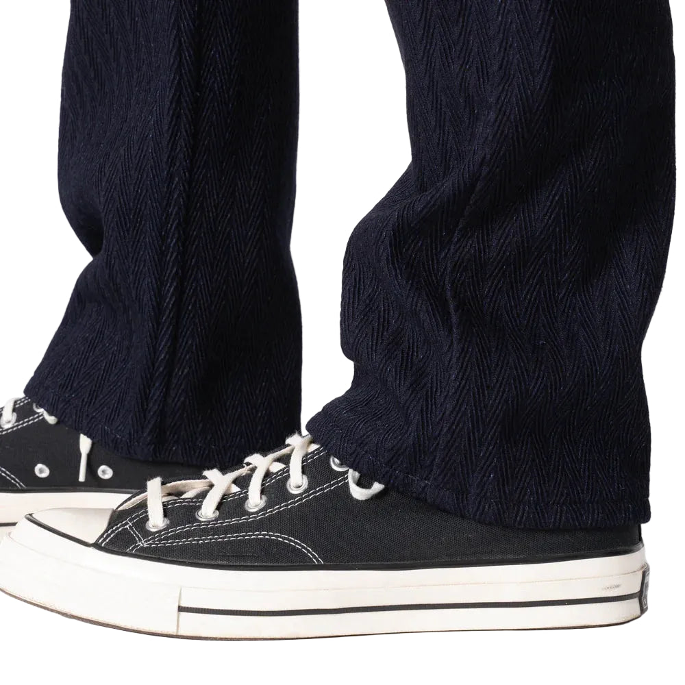 Navy pants with black sneakers on a white background