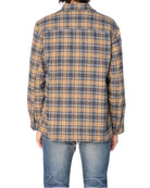 Person wearing a plaid shirt and jeans on a white background