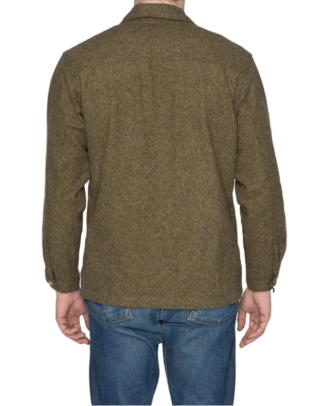 Person wearing a green jacket and blue jeans on a white background