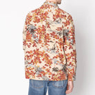 Man wearing a floral patterned shirt against a white background