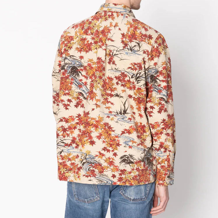 Man wearing a floral patterned shirt against a white background