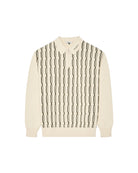 Cream-colored sweater with black geometric pattern on a white background