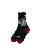 Black sock with skeleton hand design and red toes on a white background