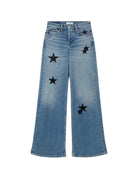 Blue jeans with star patches on a white background