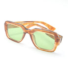 Sunglasses with brown frame and green lenses on a white background