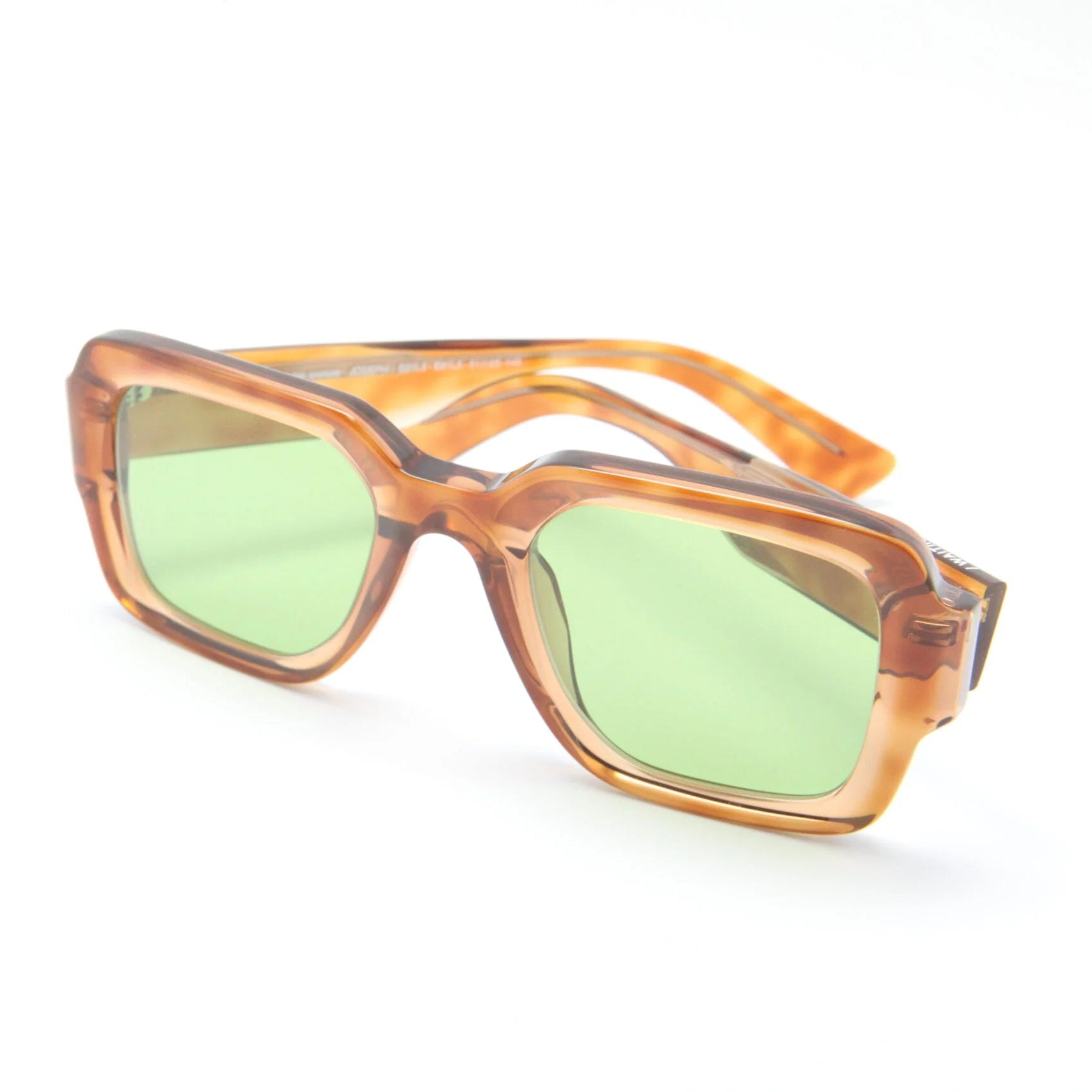 Sunglasses with brown frame and green lenses on a white background