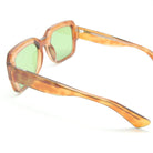 Sunglasses with orange frame and green lenses on a white background