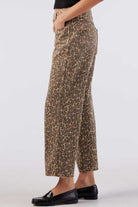 Leopard print pants worn by a person on a white background