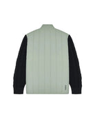 Light green quilted jacket with black sleeves on a white background