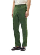 Person wearing green pants and a white shirt on a white background