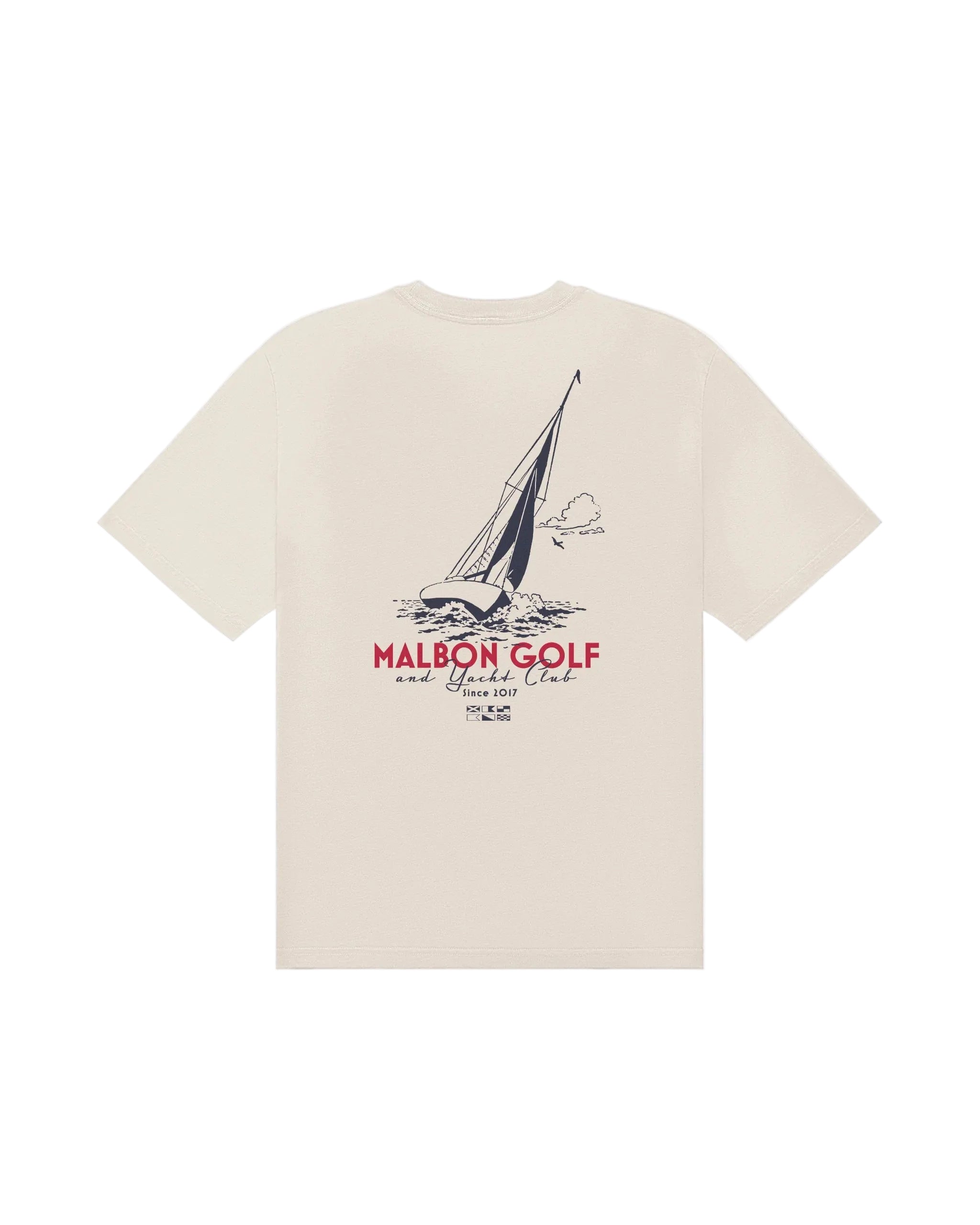Beige t-shirt with sailboat graphic and 'Malbon Golf' text on a white background