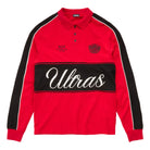 A red long-sleeve polo shirt with black shoulder panels, a black horizontal chest stripe featuring the word 'Ultras' in white script, and small black graphics on the chest, shown on a white background.