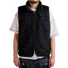 Person wearing a black vest with purple patterns on a white background