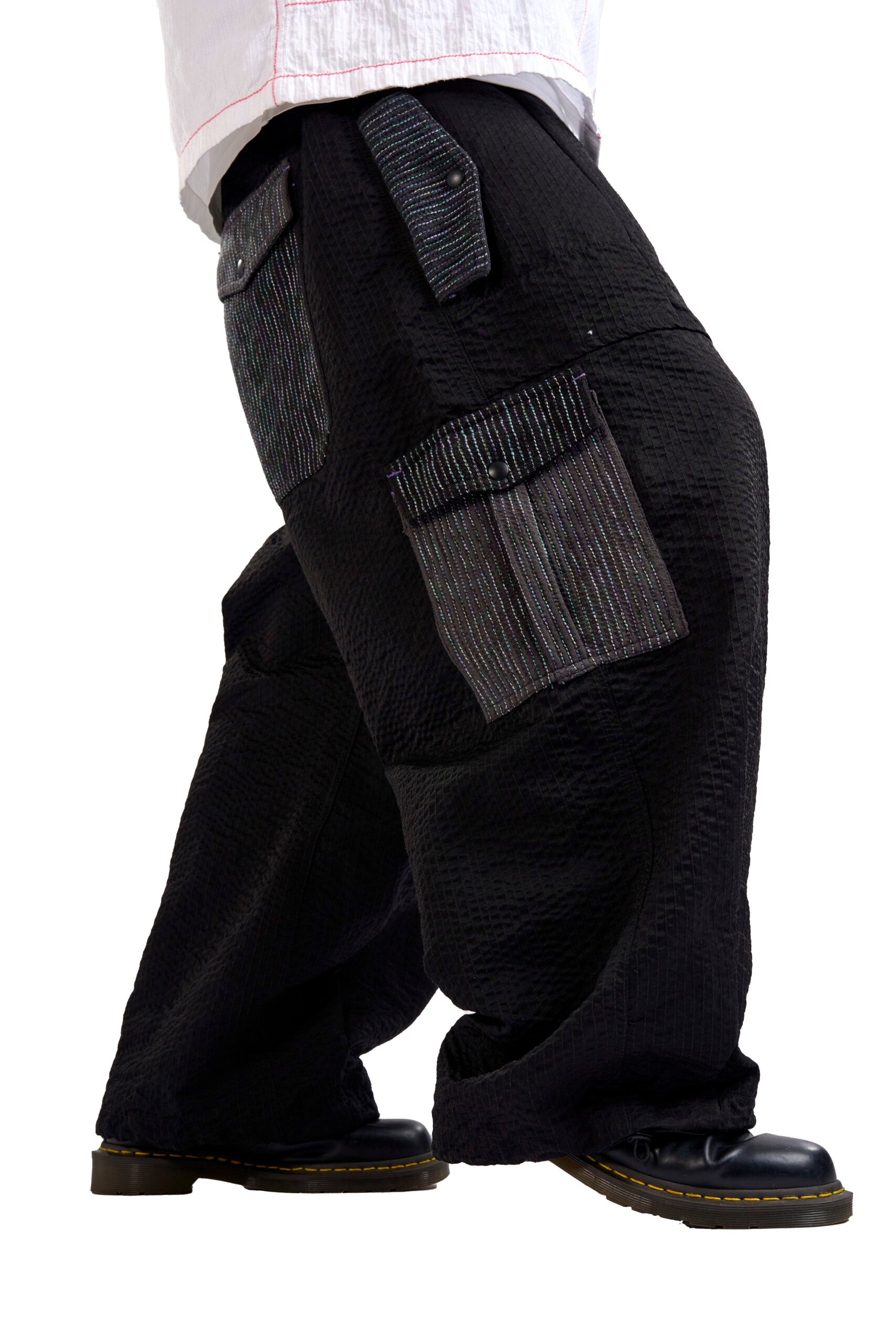 Black cargo pants with multiple pockets on a white background