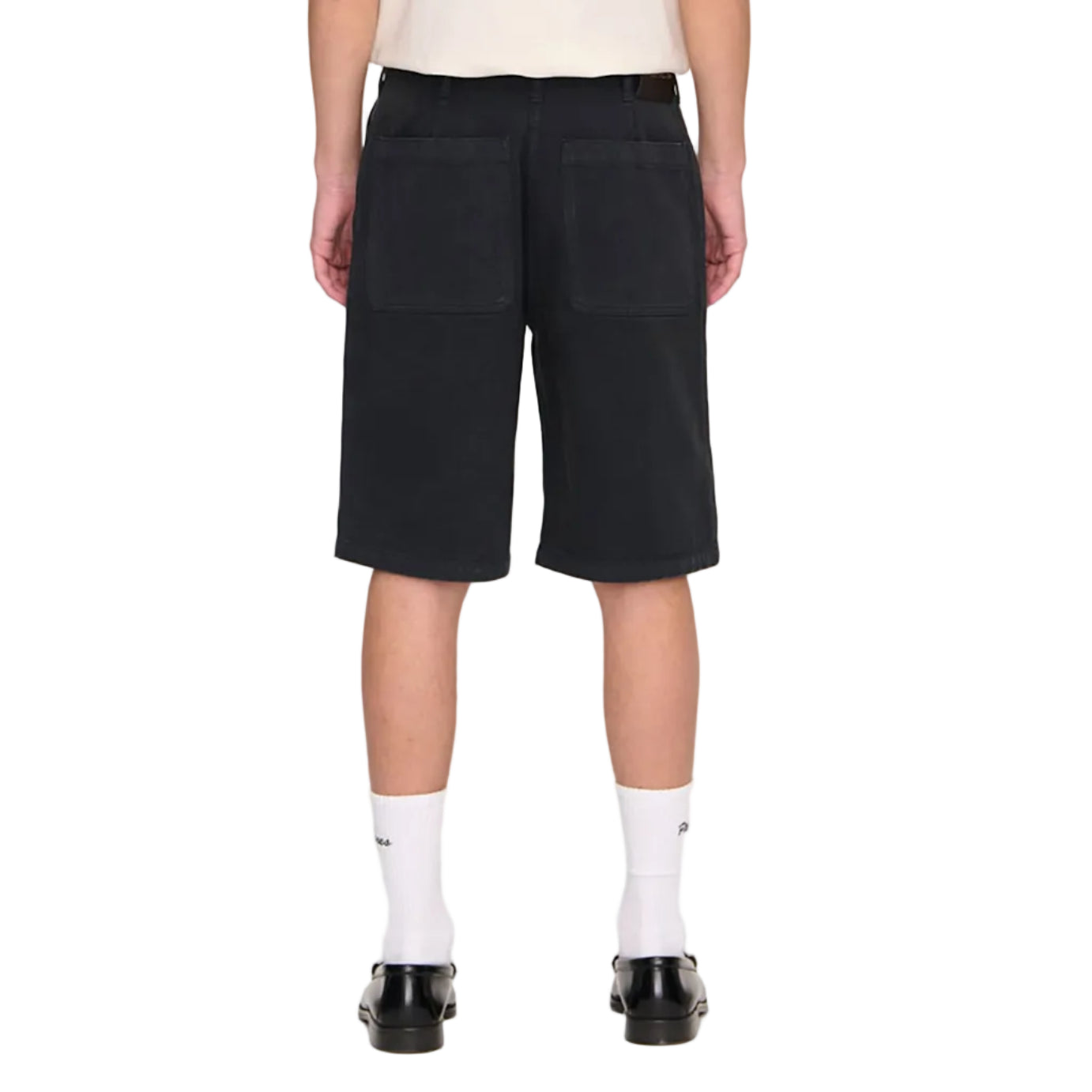 Person wearing a white t-shirt and black shorts on a plain background