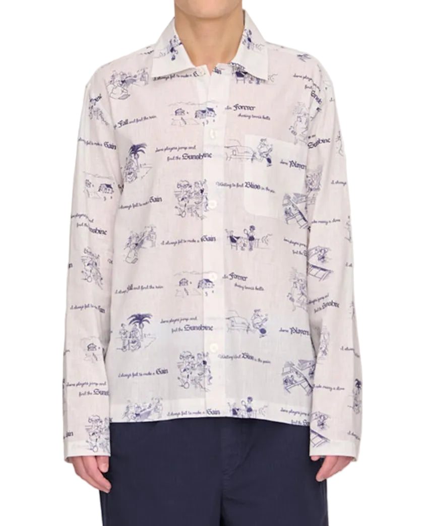 Person wearing a patterned shirt and dark pants on a white background