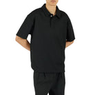 Person wearing a black outfit on a white background