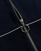 Close-up of a zipper on a dark fabric background