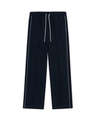 Navy track pants with white stripes on a white background