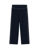 Navy track pants with white piping on a white background