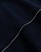 Close-up of a dark fabric with a white line running through it