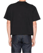 Person wearing a black t-shirt on a white background