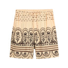 Beige shorts with black floral pattern on a light gray background