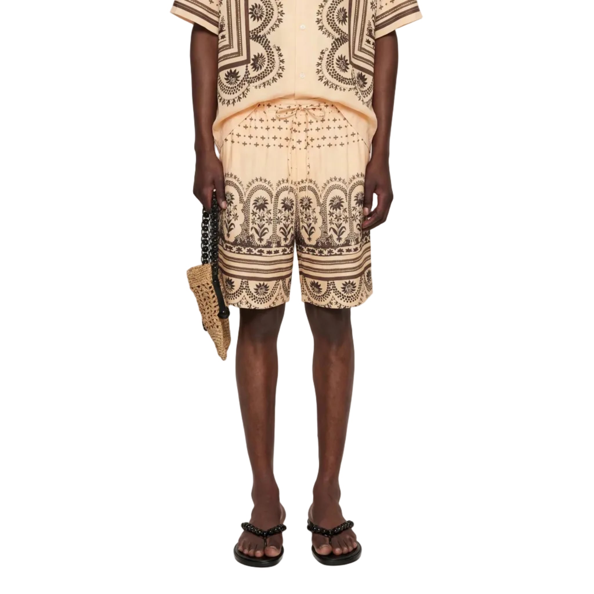 Man wearing a patterned outfit with a white background