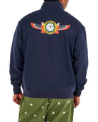 Person wearing a navy blue sweatshirt with a colorful emblem on the back, standing against a white background.