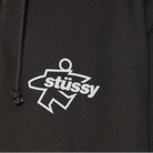 Black hoodie with white 'stussy' logo on a dark background