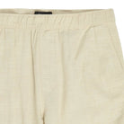 Beige pants with a brand label on a white background