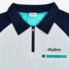 Close-up of a white and navy windbreaker with teal collar and Malbon branding.