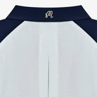 Close-up of a white and navy windbreaker collar with a branded monogram on a white background