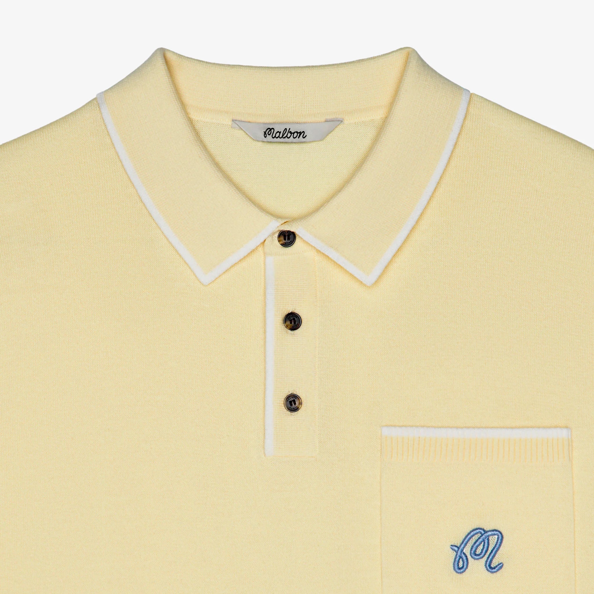 Yellow polo shirt with white trim and a small logo on a light gray background