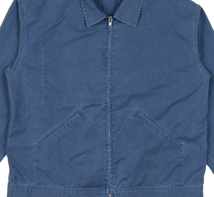 Blue denim jacket with a zipper on a white background, close-up