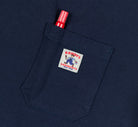 Navy blue shirt with a patch on the chest pocket featuring a cartoon character and text.
