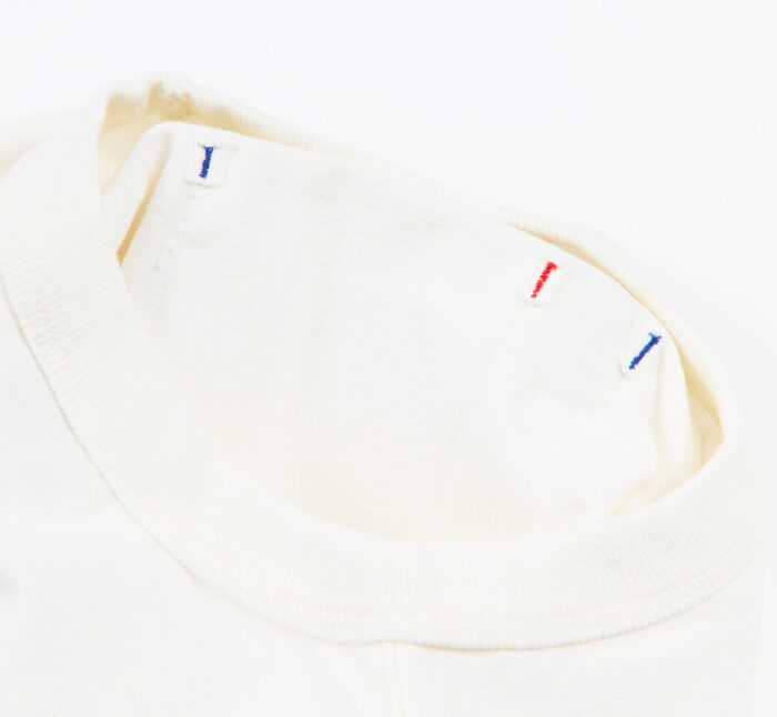 Close-up of a white t-shirt collar with colorful embroidery on a white background
