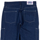 Back view of blue jeans with a brand label on a white background