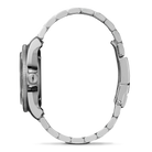 Close-up of a silver watch with a detailed band on a white background