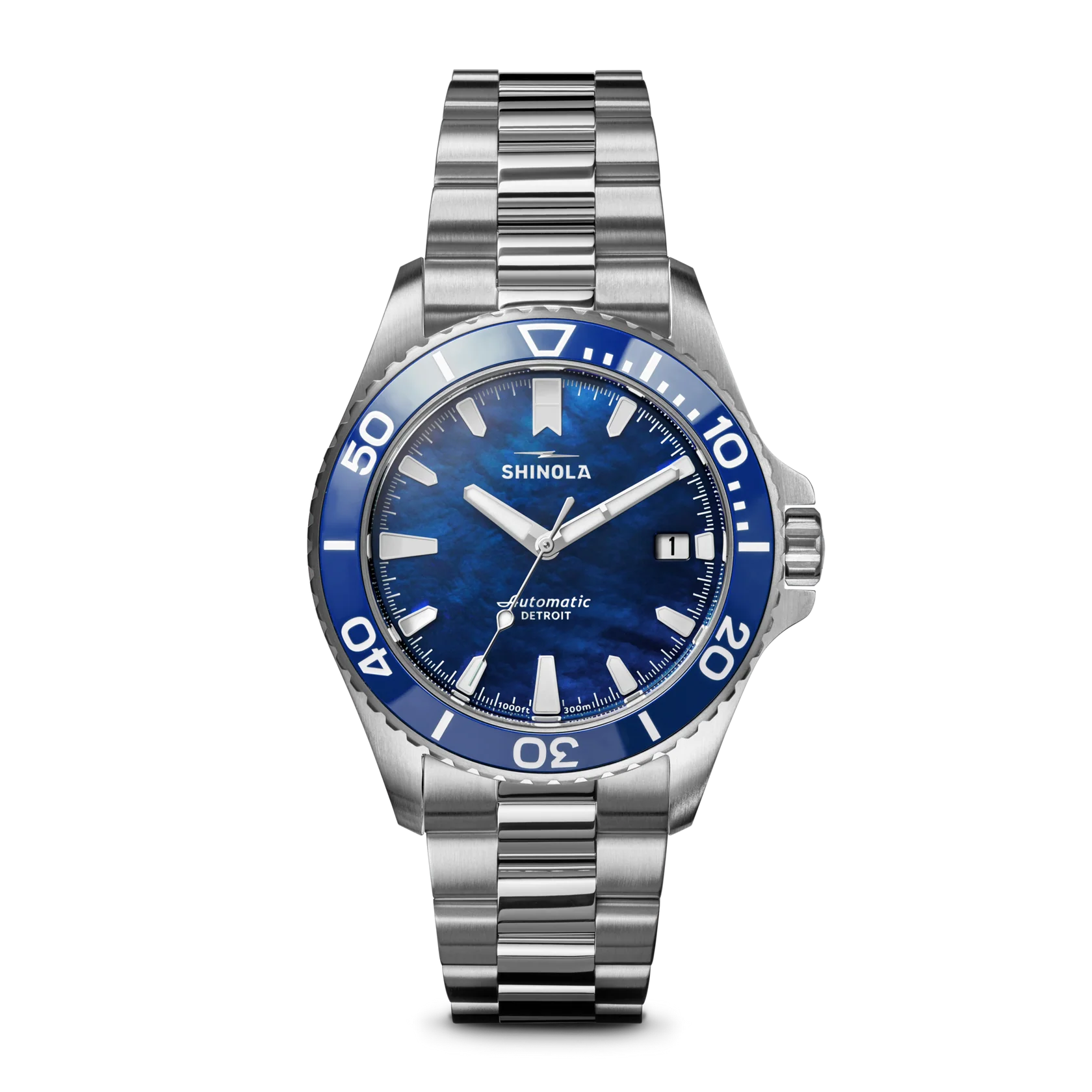 Shinola watch with blue dial and silver bracelet on a white background