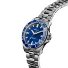 Shinola watch with blue dial and silver metal bracelet on a white background