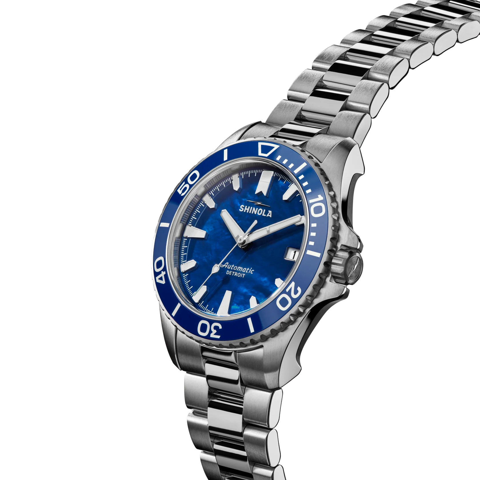 Shinola watch with blue dial and silver metal bracelet on a white background