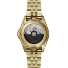 Gold wristwatch with visible mechanical components on a white background