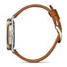 Gold and silver watch and tan band on a white background