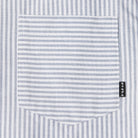 Close-up of a striped shirt pocket with a brand label.