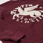 Maroon sweatshirt with white graphic design on a white background